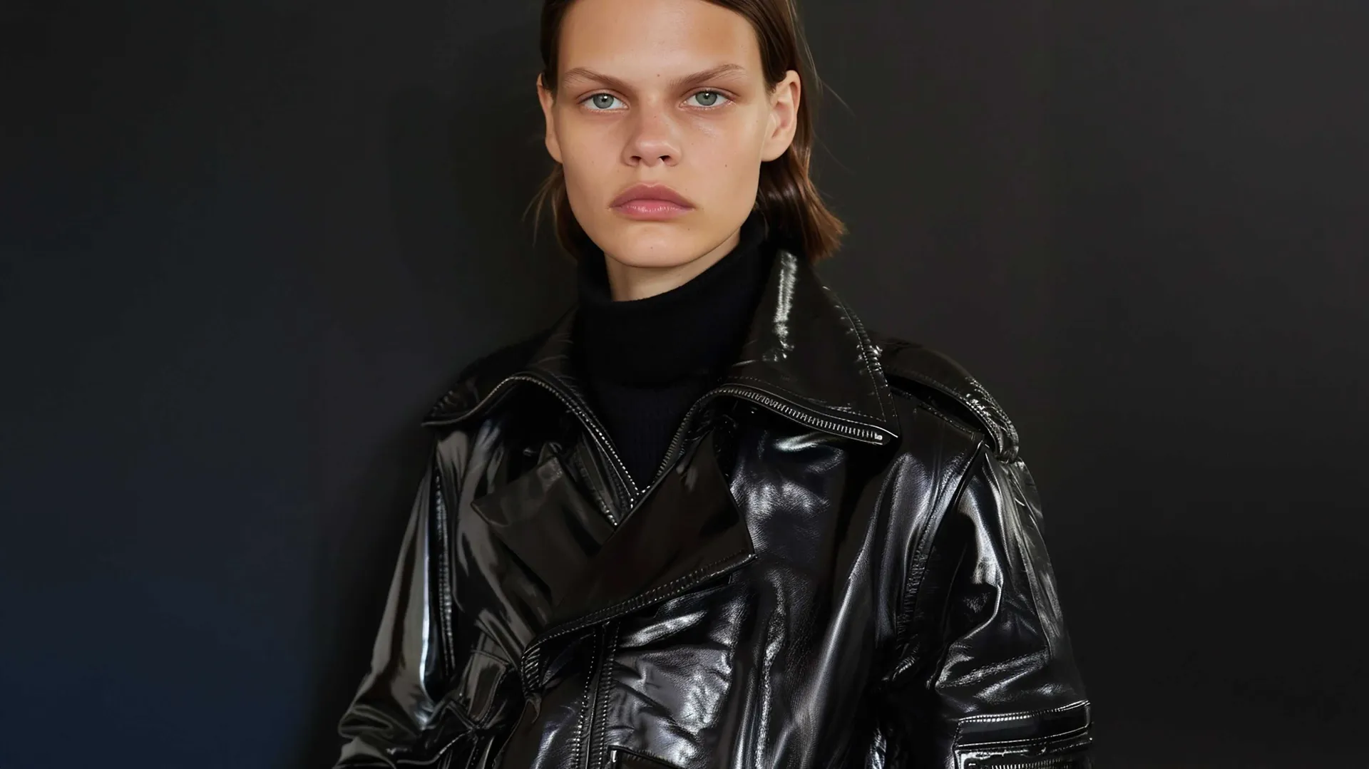A model wearing a black leather jacket